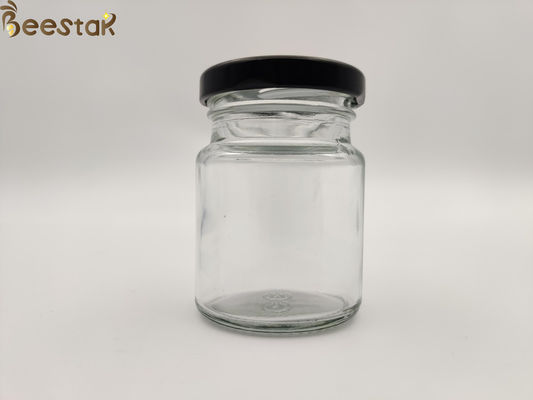 주문 까만 뚜껑을 가진 50ml 75ml 새 둥지 병 둥근 유리제 꿀 남비 유리제 콘테이너 병 온라인 제품